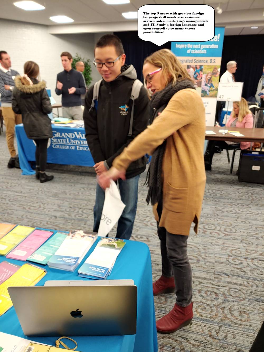 Professor Guikema talking to a student in front of the Modern Languages table at the Majors Fair
